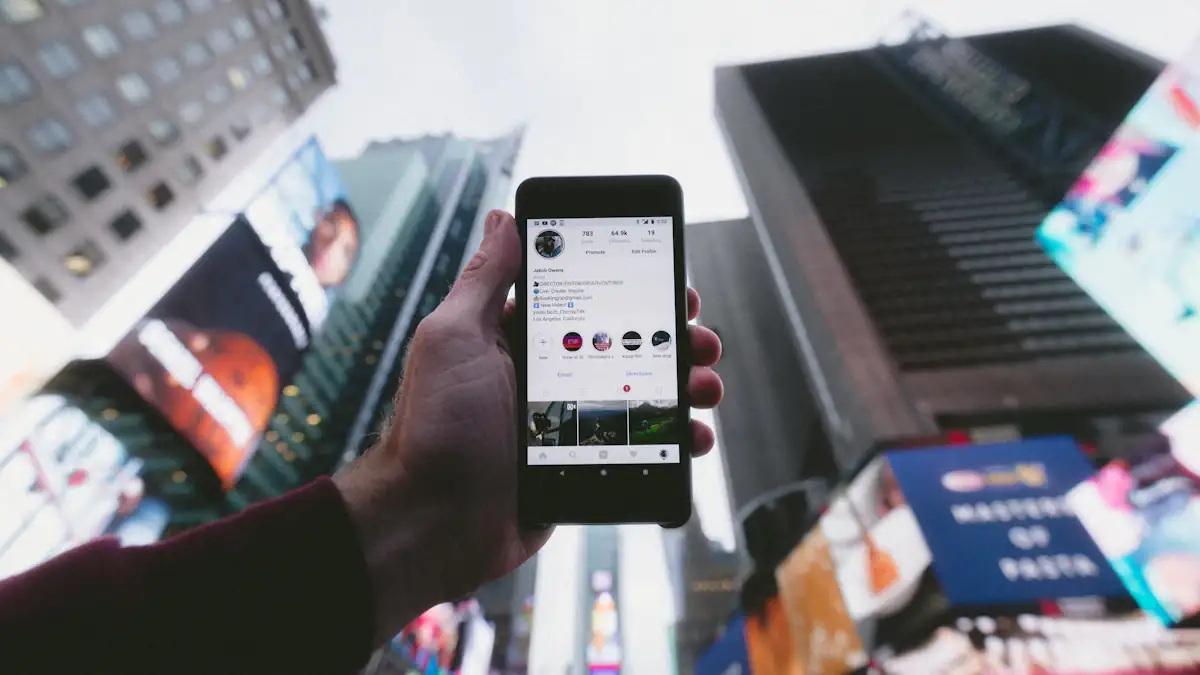 Hand holding a phone with Instagram open against city billboards